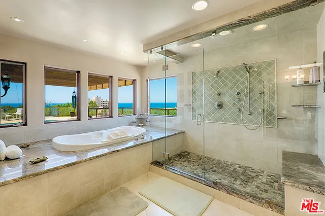 a bathroom with a granite countertop tub sink and shower