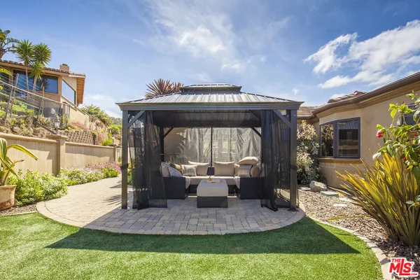 a view of an house with backyard porch and furniture