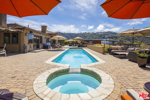 a view of a swimming pool with a lounge chairs