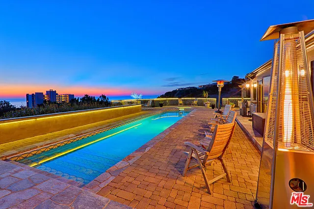 a view of swimming pool with a table and chairs