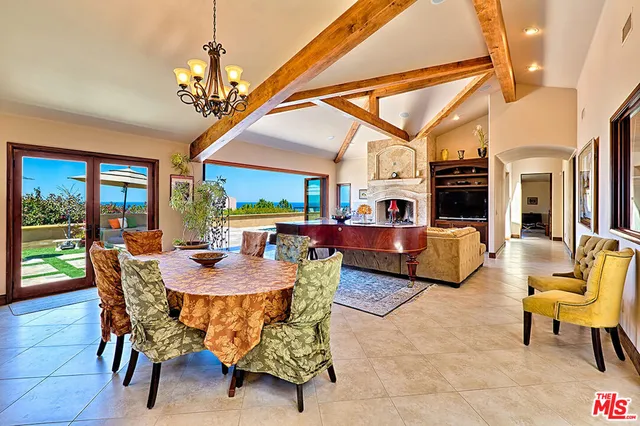 a view of a dining room with furniture a chandelier and wooden floor