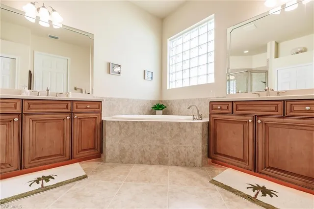 a spacious bathroom with a sink a mirror and a bathtub