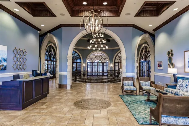 a hall with couches and chandelier