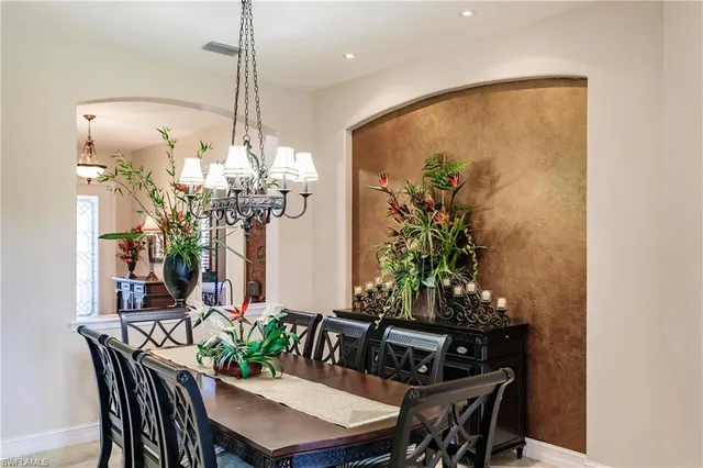 a view of a dining room with furniture and chandelier