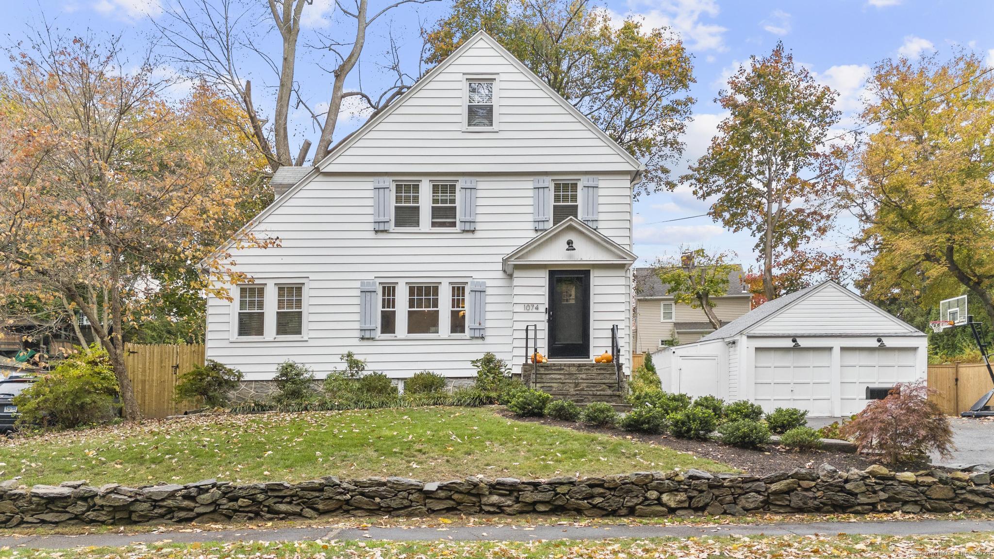 1074 Valley Road Fairfield, CT 06825 - Photo 1 of 1 a front view of a house with a yard