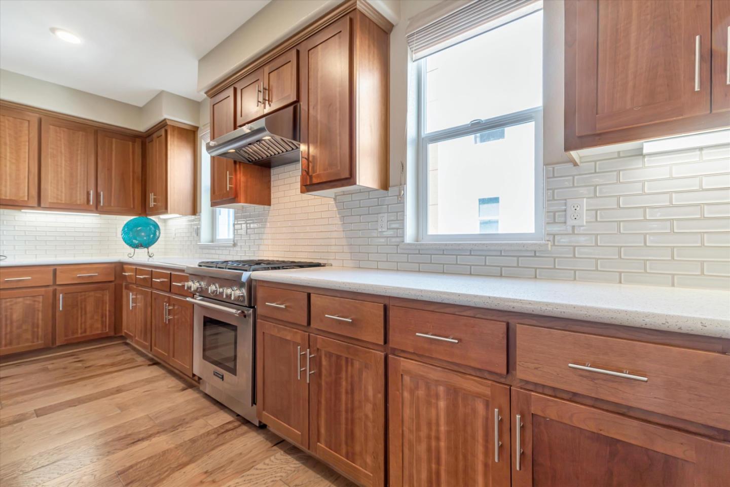 1480 Bond Street Milpitas, CA 95035 - Photo 11 of 51 a kitchen with stainless steel appliances granite countertop wooden cabinets a sink and a window