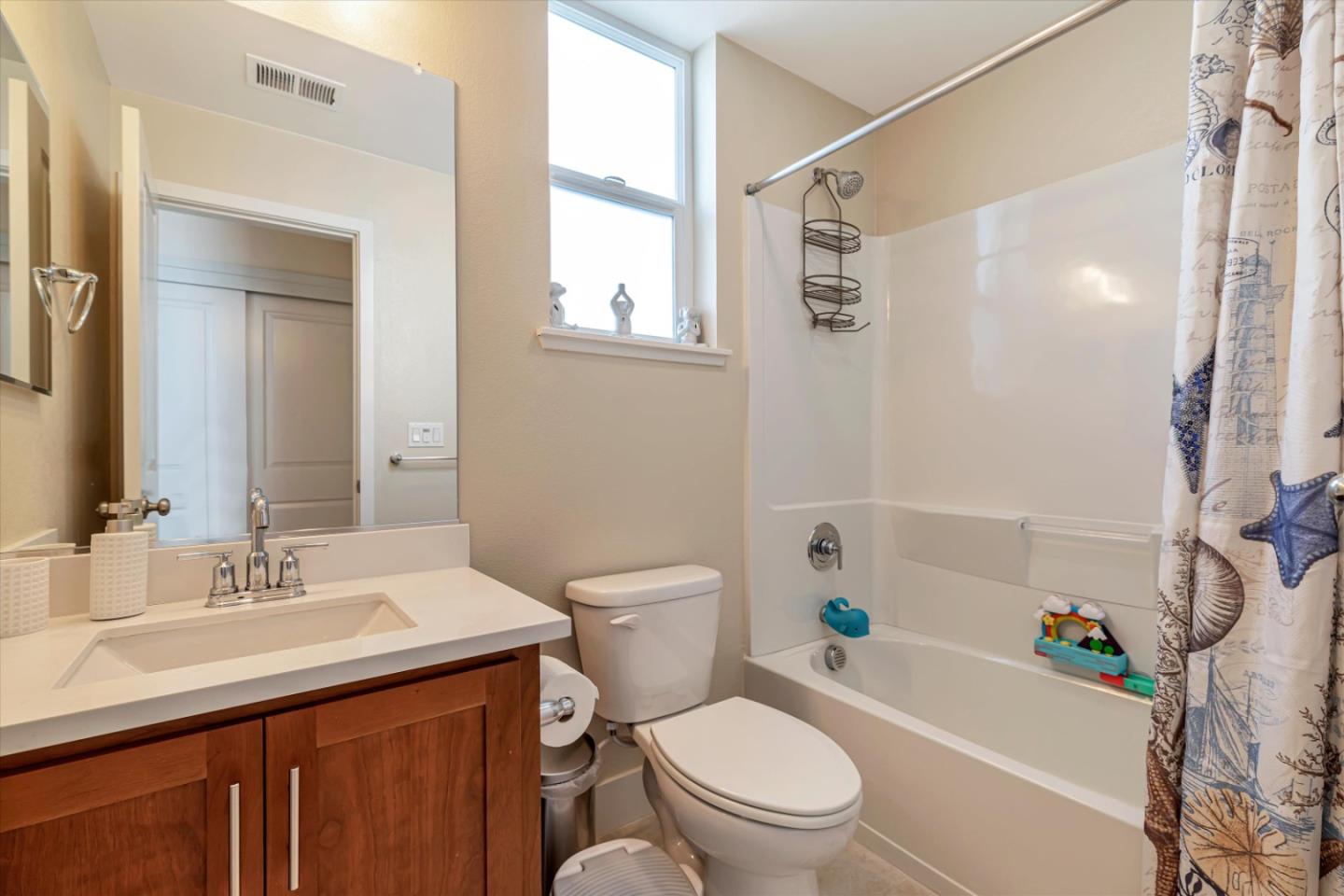 1480 Bond Street Milpitas, CA 95035 - Photo 29 of 51 a bathroom with a sink a toilet a mirror a vanity and shower