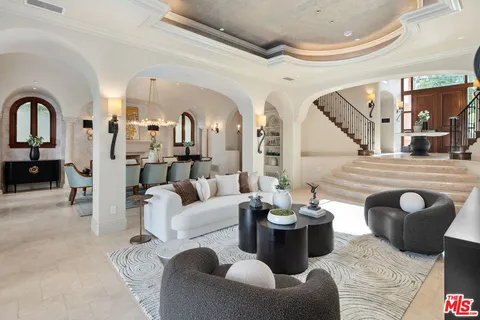 a bedroom with a large bed and a chandelier