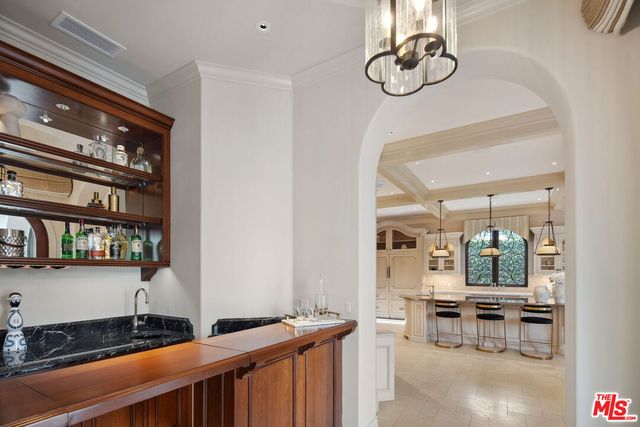 a bathroom with a granite countertop sink a mirror a vanity and shower