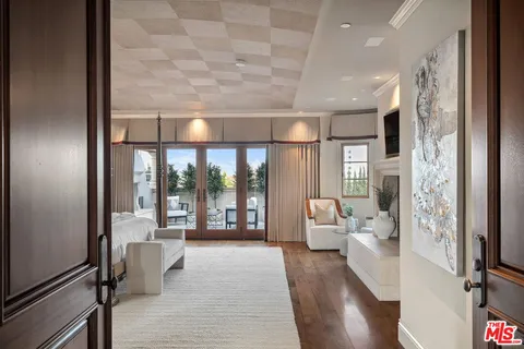 a bedroom with a large bed and a large window