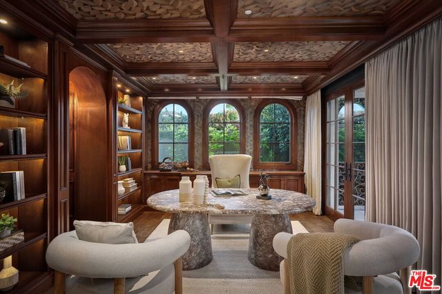 a view of a dining room with furniture and chandelier