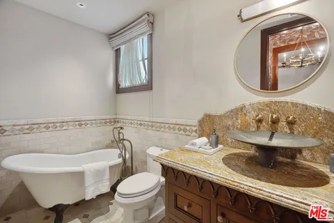 a kitchen with a stove a sink and a chandelier