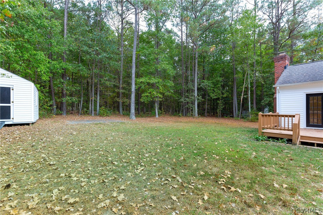 3561 Markey Road Midlothian, VA 23112 - Photo 45 of 48 a backyard of a house with large trees and plants