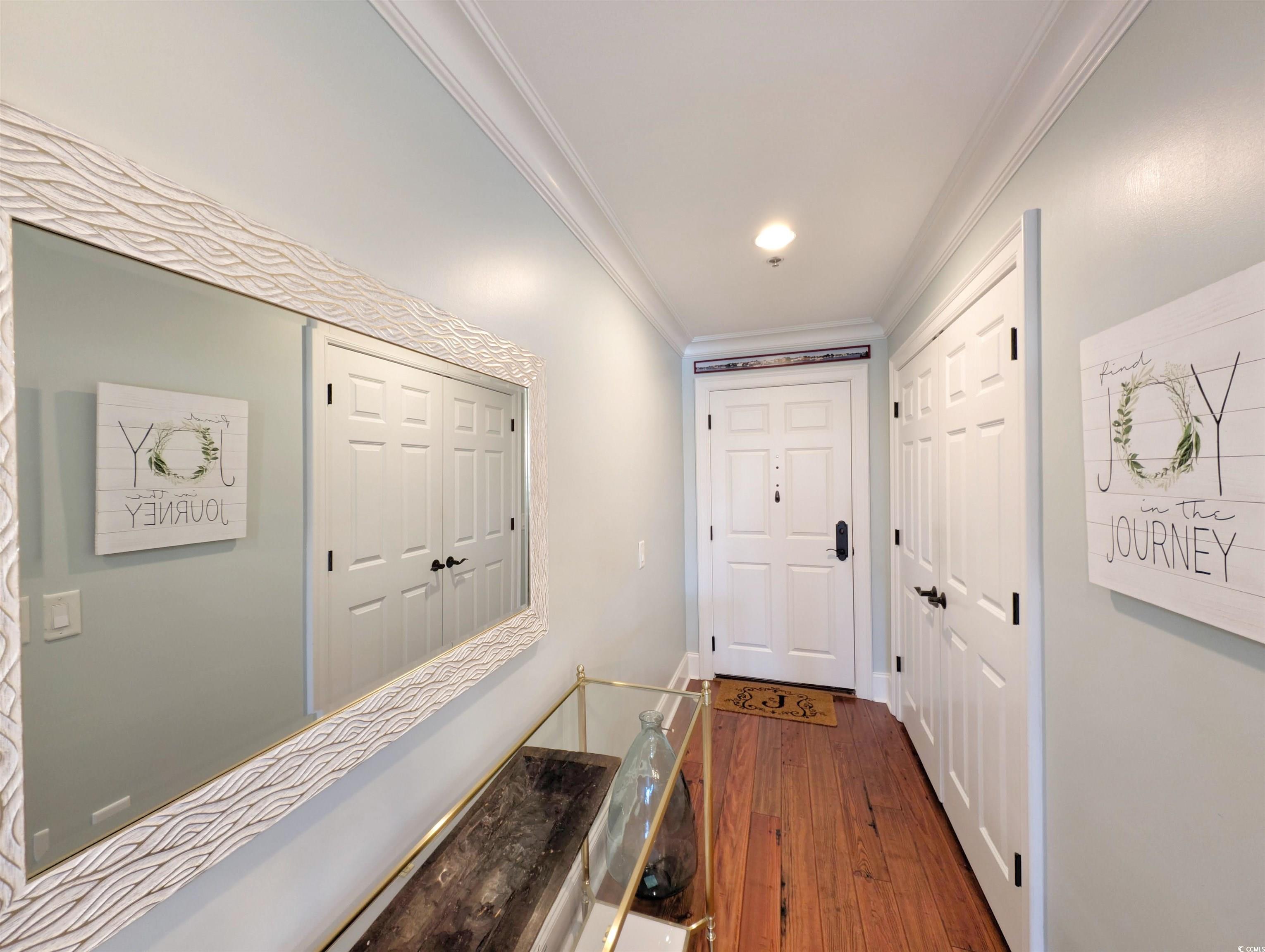815 Front Street, Unit 3J Georgetown, SC 29440 - Photo 3 of 39 Hall with crown molding and dark wood-style floori