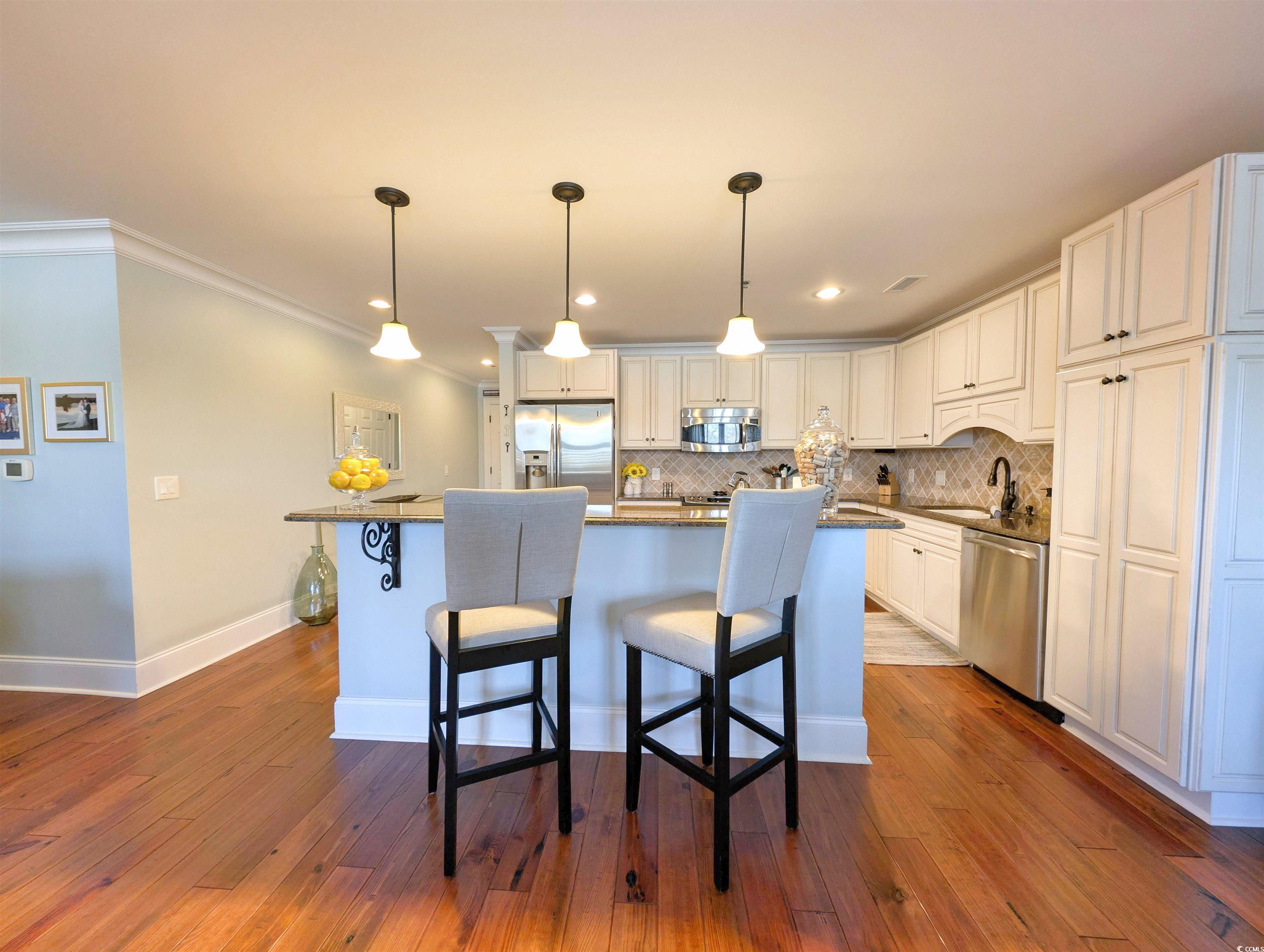 815 Front Street, Unit 3J Georgetown, SC 29440 - Photo 8 of 39 Kitchen featuring ornamental molding, white cabine
