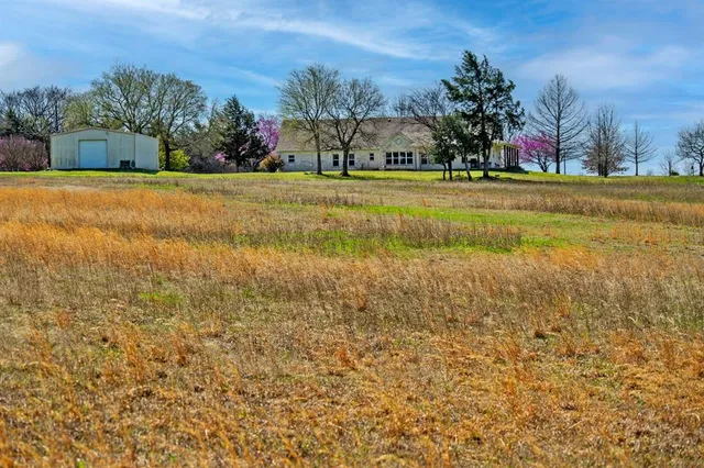 a view of a yard with a house in the background
