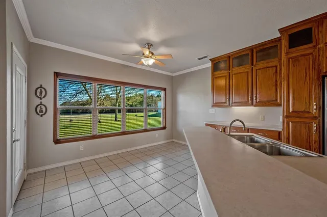a view of a kitchen with a sink and a window