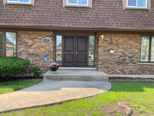 7037 West Main Street Niles, IL 60714 - Photo 2 of 29 a front view of a house with garden