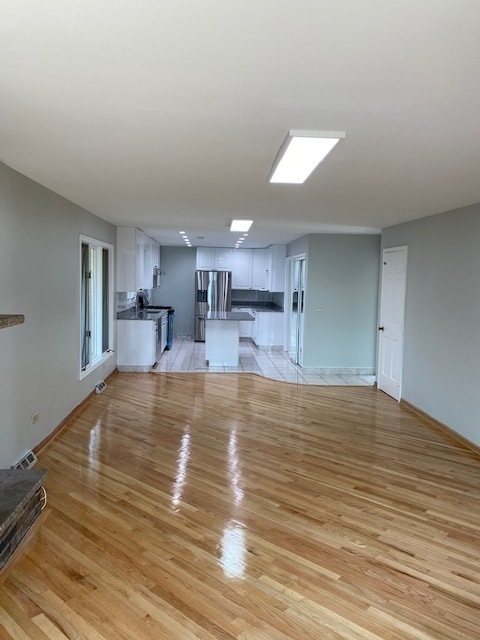 7037 West Main Street Niles, IL 60714 - Photo 14 of 29 a view of a kitchen with kitchen island a sink stainless steel appliances and cabinets