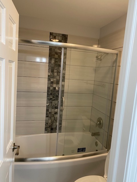 7037 West Main Street Niles, IL 60714 - Photo 16 of 29 a bathroom with a bathtub and shower