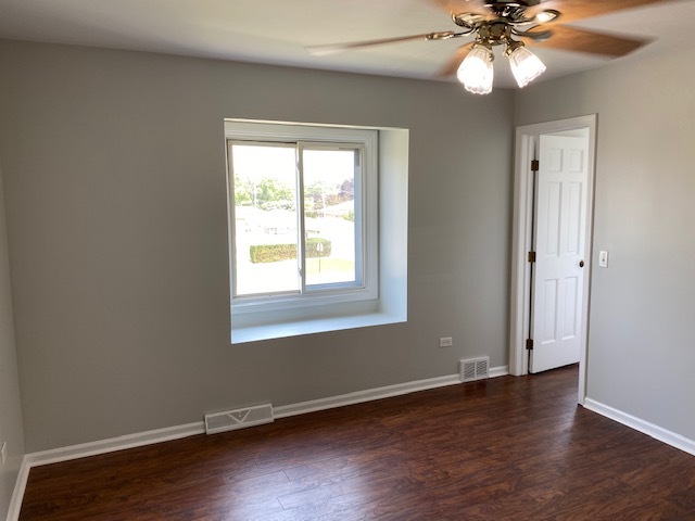7037 West Main Street Niles, IL 60714 - Photo 18 of 29 a view of an empty room with wooden floor and a window