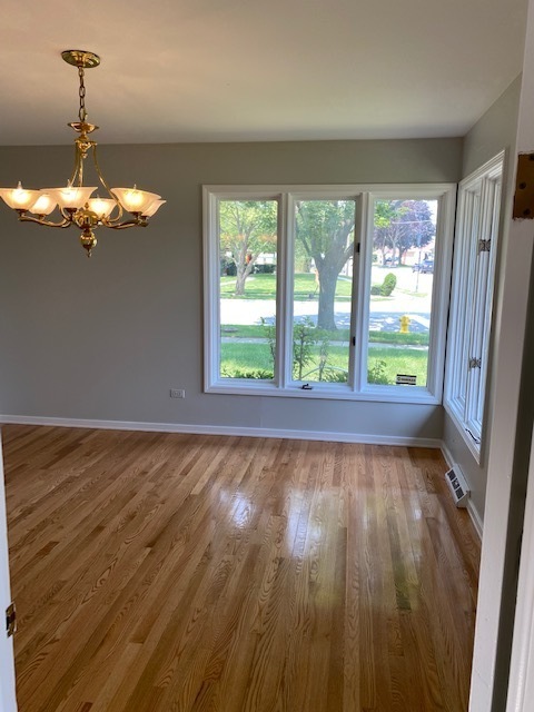 7037 West Main Street Niles, IL 60714 - Photo 21 of 29 a view of an empty room with wooden floor and a window