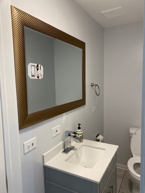 7037 West Main Street Niles, IL 60714 - Photo 23 of 29 a bathroom with a sink mirror and toilet