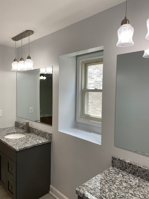 7037 West Main Street Niles, IL 60714 - Photo 24 of 29 a bathroom with a sink and a mirror