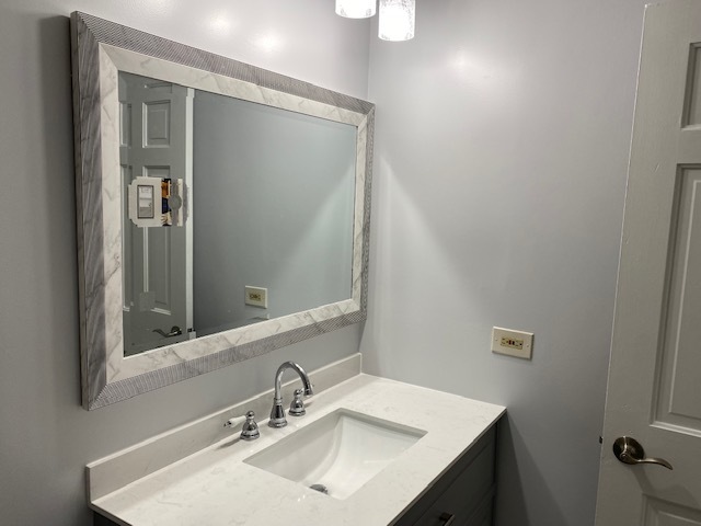 7037 West Main Street Niles, IL 60714 - Photo 26 of 29 a bathroom with a sink and a mirror