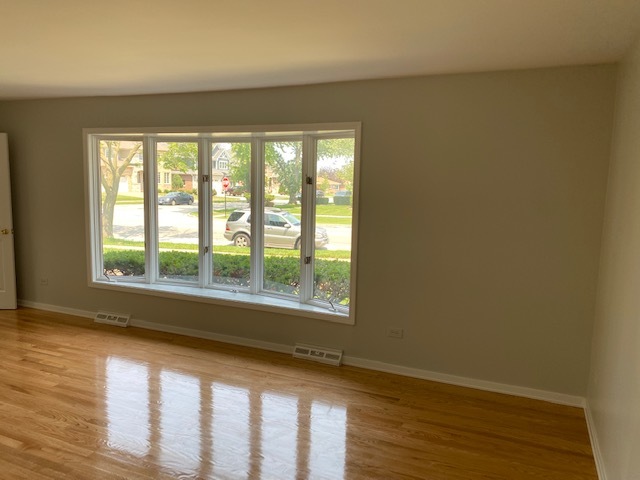 7037 West Main Street Niles, IL 60714 - Photo 5 of 29 a view of an empty room with wooden floor and a window