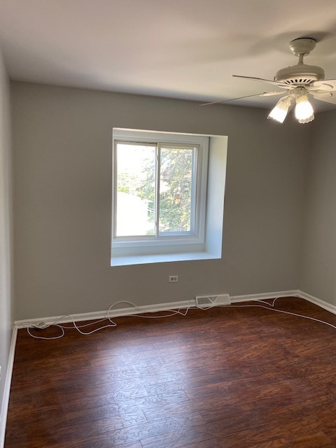 7037 West Main Street Niles, IL 60714 - Photo 7 of 29 an empty room with wooden floor and windows