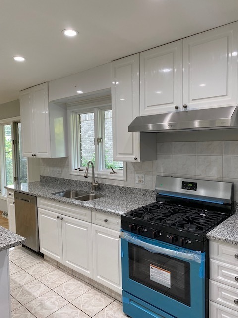 7037 West Main Street Niles, IL 60714 - Photo 9 of 29 a kitchen with granite countertop a sink stove and cabinets