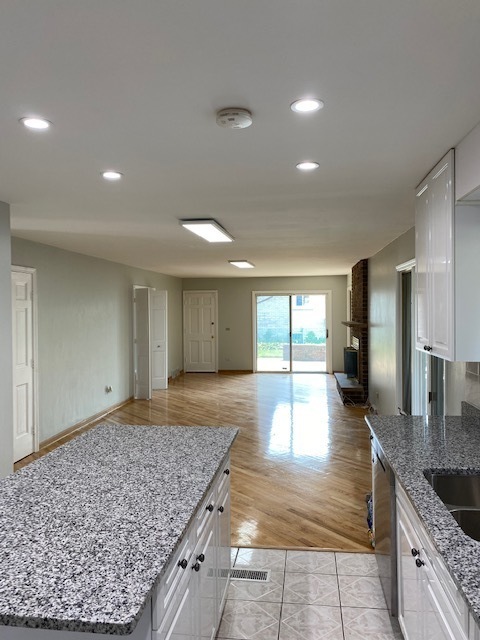 7037 West Main Street Niles, IL 60714 - Photo 10 of 29 a view of a kitchen with kitchen island a sink wooden floor and glass doors