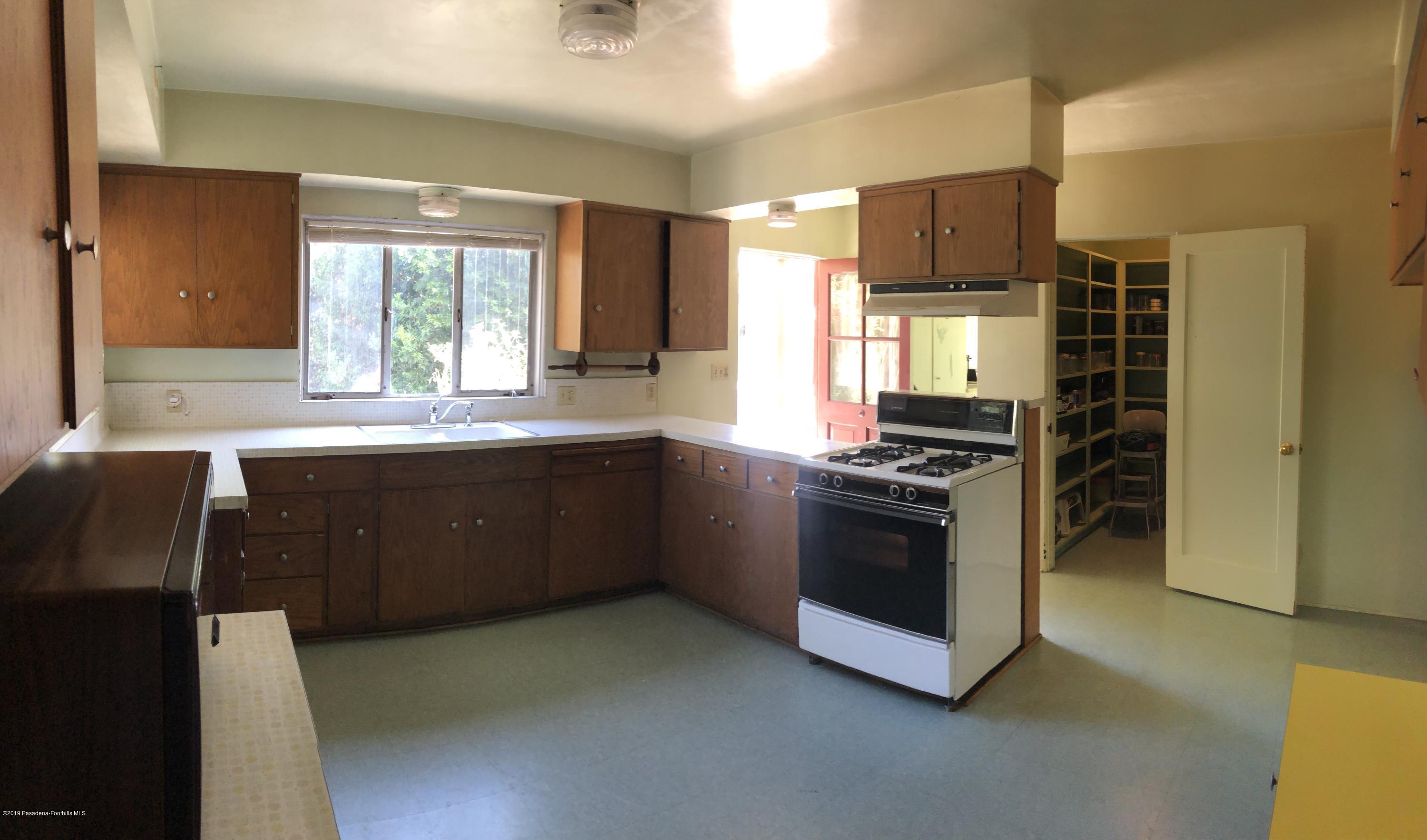 8744 Duarte Road San Gabriel, CA 91775 - Photo 9 of 16 a kitchen with stainless steel appliances granite countertop a stove a sink and a refrigerator