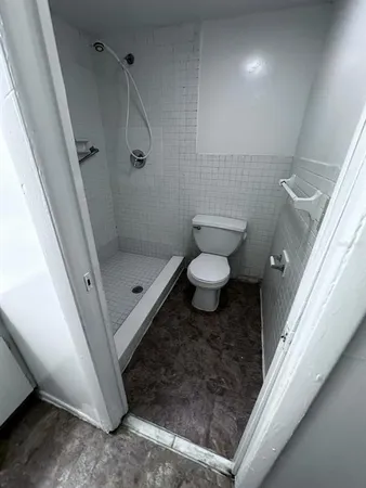 a bathroom with a granite countertop shower and a sink
