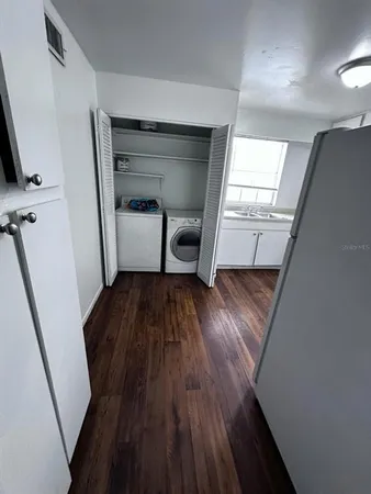 a room with a hardwood floor and a window