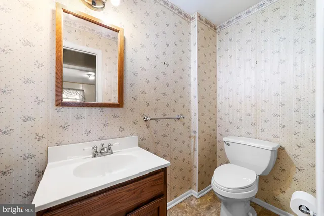 a bathroom with a sink toilet and mirror