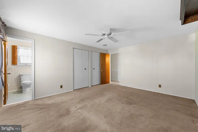 a view of an empty room with a bathroom