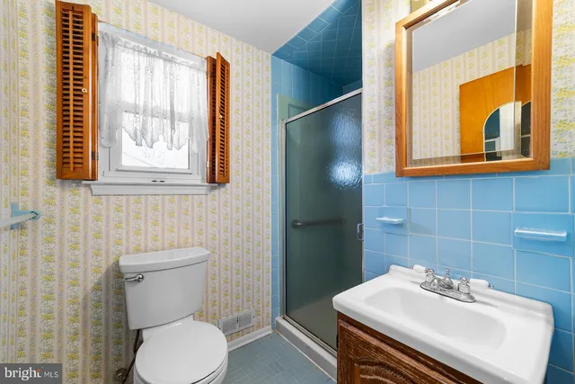 a bathroom with a sink mirror and toilet