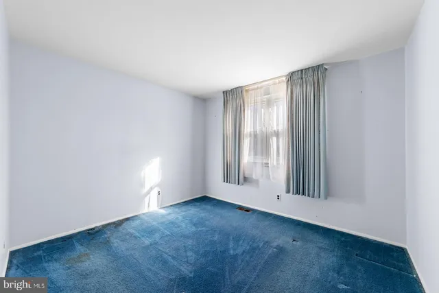 an empty room with a empty space and a window