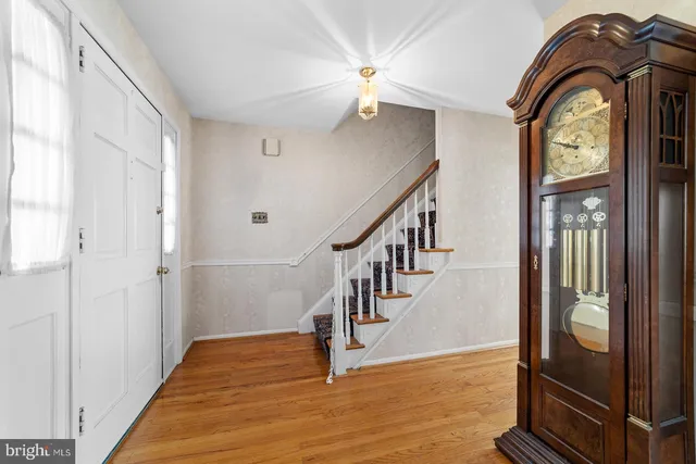 a view of entryway and hall with wooden floor