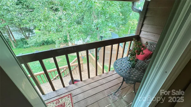 a view of walk in closet and empty room