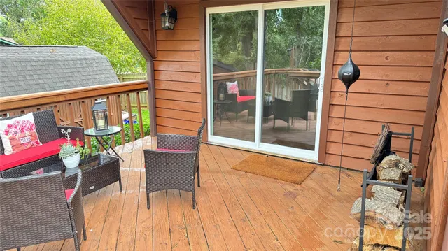 a view of a chairs and table on the wooden deck