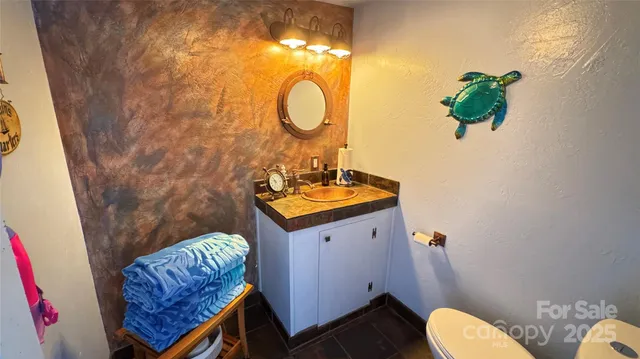 a view of a dry field with mountains in the background