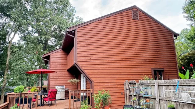 a kitchen with stainless steel appliances granite countertop a stove top oven a sink dishwasher and a dining table with wooden floor