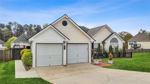 a front view of a house with a yard