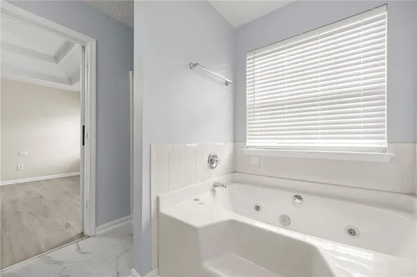 a bathroom with a bathtub and a shower