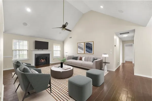 a living room with fireplace furniture and a wooden floor