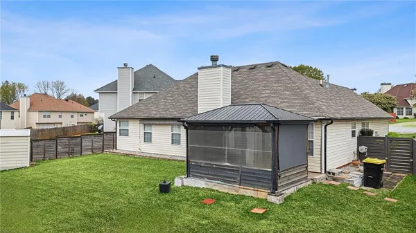 a backyard of a house with table and chairs