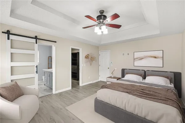 a bedroom with a large bed and a chandelier